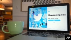 The login/sign up screen for a Twitter account is seen on a laptop computer, April 27, 2021, in Orlando, Fla.