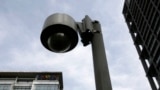 FILE - A surveillance camera is seen near a building.