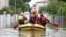 FILE - Firefighters transport food and water to people who are still in their homes after heavy rains hit Italy's Emilia Romagna region, in Lugo, Italy, May 19, 2023. 