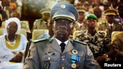 FILE - Coup leader General Amadou Sanogo attends a ceremony as former parliament speaker Dioncounda Traore (unseen) is sworn in as Mali's interim president in the captial Bamako.