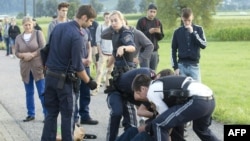 Austrian policemen arrest a suspect on August 16, 2016 at the train station Sulz-Röthis in Vorarlberg, Austria, after he had attacked two train passengers with a knife.