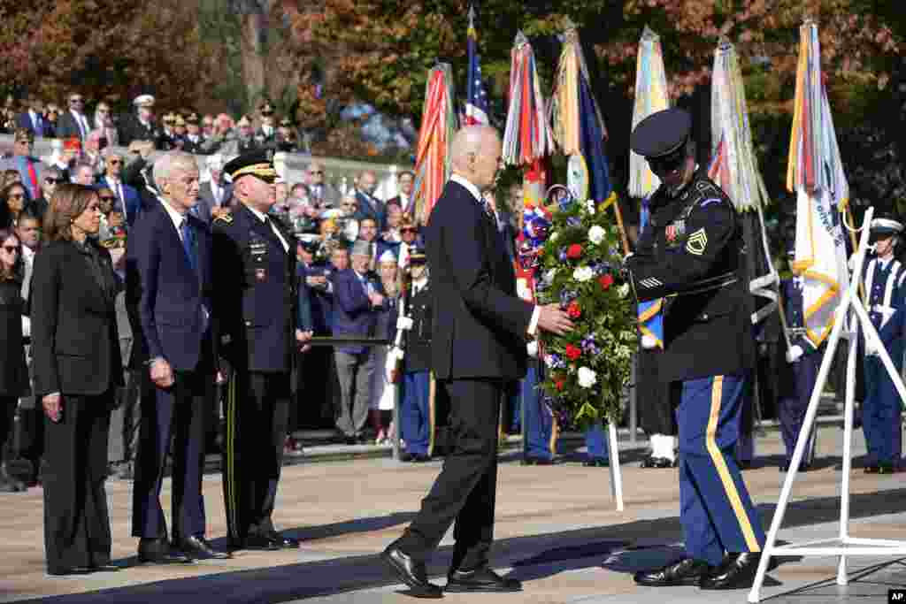 President Joe Biden lays a wreath at the Tomb of the Unknown Soldier as Vice President Kamala Harris, from left, Veterans Affairs Secretary Denis McDonough and Maj. Gen. Trevor Bredenkamp, commanding general of the Joint Task Force-National Capital Region and the U.S. Military District of Washington, watch, on National Veterans Day Observance at Arlington National Cemetery in Arlington, Virginia.