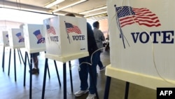 FILE - U.S. voters cast their ballots at a polling station in Alhambra, California, Nov. 4, 2014. 