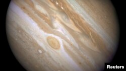 FILE - The planet Jupiter is shown with one of its moons, Ganymede (bottom), in this NASA handout taken April 9, 2007, and obtained by Reuters, March 12, 2015. 