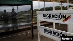 The Colombian migration logo is seen on a fence on the Simon Bolivar cross-border bridge between Venezuela and Colombia, in Cucuta, Colombia, Feb. 27, 2019. 