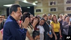 Venezuelan President Hugo Chavez (L) attends a mass at the military academy in Caracas, Venezuela July 12, 2011. Picture taken on July 12, 2011