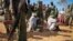 FILE - In this photo released by the African Union-United Nations Information Support Team, alleged al-Shabab members are blindfolded and guarded in Kismayo, southern Somalia on Oct. 3, 2012.