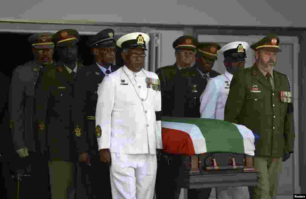 The coffin of former South African President Nelson Mandela leaves the makeshift tent for a traditional burial in Qunu, South Africa, Dec. 15, 2013.&nbsp;