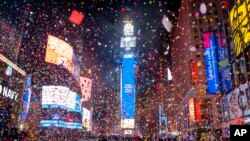 Confetti flies after the Times Square New Year&#39;s Eve Ball drops in a nearly empty Times Square, as the area normally packed with revelers remained closed off due to the ongoing coronavirus pandemic.