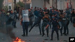 Security forces try to disperse demonstrators during ongoing anti-government protests near Tahrir square, Baghdad, Iraq, July 27, 2020. 
