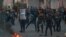 Security forces try to disperse demonstrators during ongoing anti-government protests near Tahrir square, Baghdad, Iraq, July 27, 2020. 