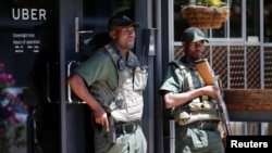 Private security guard stand outside Uber offices in Parktown, a suburb of Johannesburg, South Africa, March 10, 2017. 