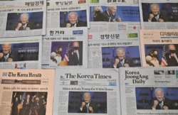 FILE - This photo illustration taken in Seoul on Nov. 9, 2020 shows the frontpages of South Korea's newspapers carrying stories and pictures of US President-elect Joe Biden.