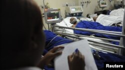 A nurse takes notes at the Kenyatta National hospital after patients drank an illegal alcohol that killed seven people and caused 10 others to go blind, in Nairobi, Kenya, April 9, 2010.