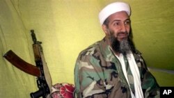 In this Dec. 24, 1998 file photo, al Qaida leader Osama bin Laden speaks to a selected group of reporters in mountains of Helmand province in southern Afghanistan