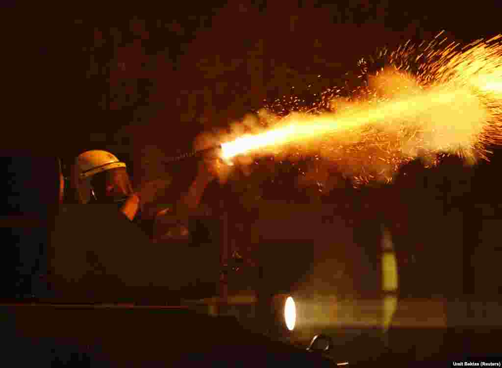 A riot police fires tear gas against anti-government protesters during clashes in Ankara early June 12, 2013. Turkish Prime Minister Tayyip Erdogan demanded on Tuesday an immediate end to 10 days of demonstrations. REUTERS/Umit Bektas (TURKEY - Tags: POLI