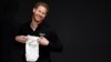 Britain's Prince Harry holds a baby suit during the official launch of the one year countdown to the Invictus Games The Hague 2020, in The Hague, Netherlands, May 9, 2019. 