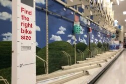 FILE- In this June 11, 2020 photo, bicycle display racks are empty at a Target in Milford, Mass. A bicycle rush has been brought on by the coronavirus pandemic.