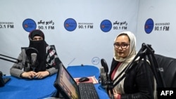 FILE - Station director Saba Chaman, right, and her colleague work in a studio at Radio Begum in Kabul, Afghanistan, Nov. 28, 2021.