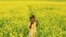 A girl plays in a mustard field in Munshiganj, Bangladesh.