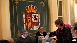 A woman cast her vote in a voting station in Madrid, November 20, 2011.