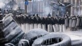 Police stand at the site of clashes with anti-government protesters in Kyiv, Jan. 24, 2014. 