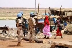 FILE - Senegalese soldiers of the U.N. peacekeeping mission in Mali, MINUSMA (United Nations Multidimensional Integrated Stabilization Mission in Mali), patrol on foot in the streets of Gao, July 24, 2019, a day after a suicide bomb attack.