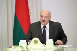 FILE - Belarusian President Alexander Lukashenko chairs a meeting with officials in Minsk, Belarus, June 19, 2020.