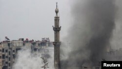 Smoke rises from a mosque and another building during heavy fighting between the Free Syrian Army and President Bashar al-Assad's forces, in the Jobar area of Damascus Feb. 6, 2013. 