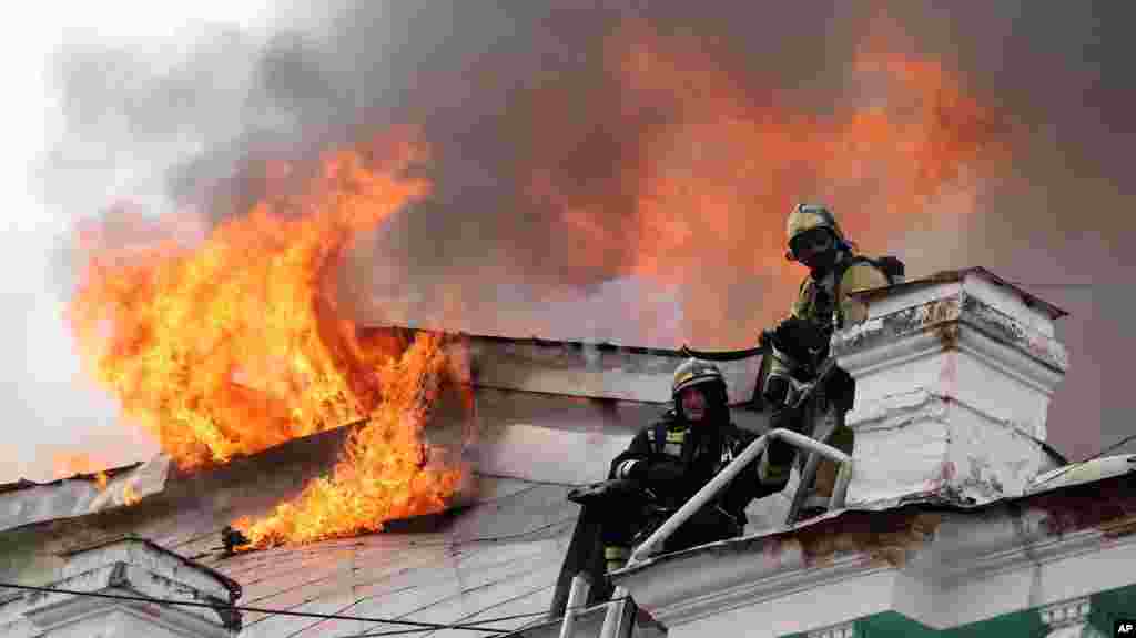 Firefighters work to extinguish a fire at a local clinic of cardiac surgery in the city of Blagoveshchensk, Russia.