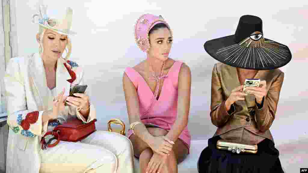 People wait to enter the Fashion on the Field event ahead of the Melbourne Cup horse race at the Flemington Racecourse in Melbourne, Australia.