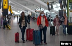 Passengers wait at Heathrow Terminal 5 airport