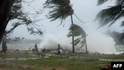This handout photo taken and received on March 14, 2015 by UNICEF Pacific shows waves and scattered debris along the coast, caused by Cyclone Pam, in the Vanuatu capital of Port Vila. 