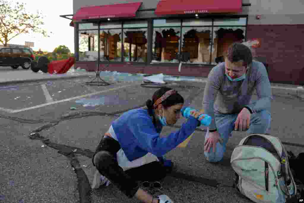 A protester washes her eyes, May 28, 2020, in St. Paul, Minn. 