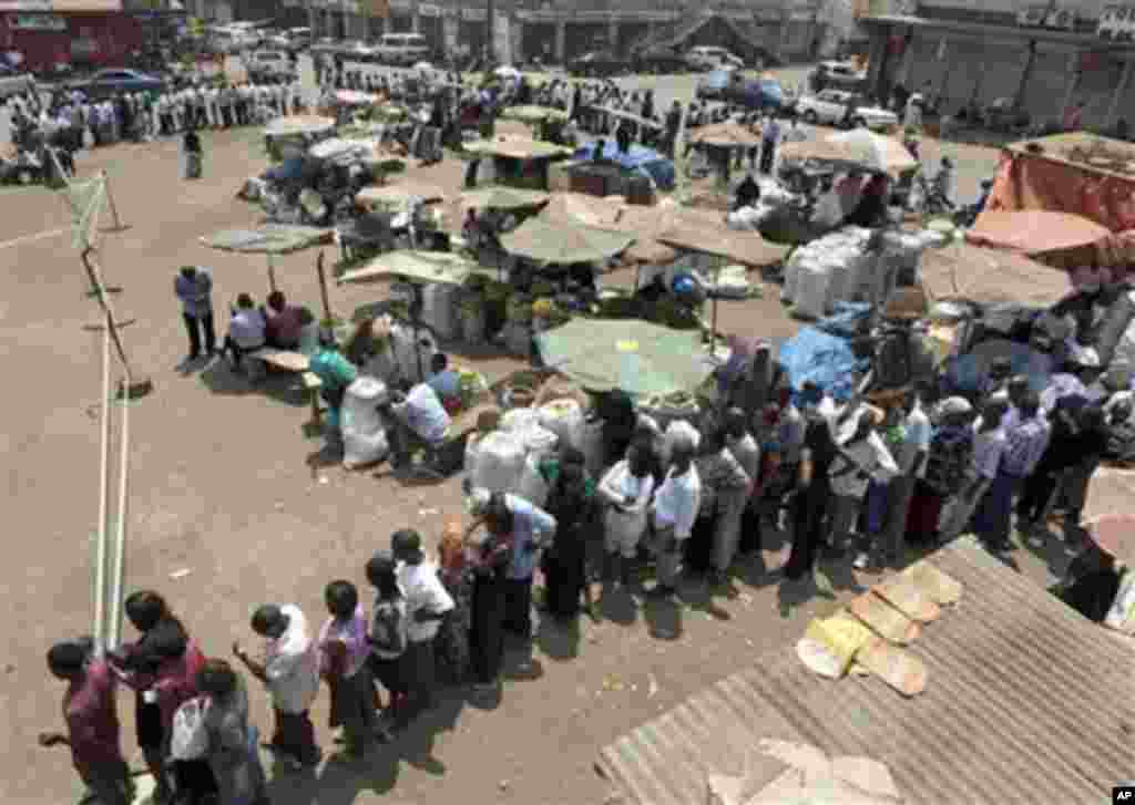 People queuing at the Nakasero polling station in the center of Kampala, Uganda, Friday, Feb. 18, 2011, as they wait to cast their vote