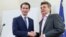 The leader of Austria's Green Party, Werner Kogler, right, and the head of the People's Party, Sebastian Kurz, shake hands after delivering a statement, in Vienna, Austria Jan. 1, 2020.