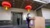 A FedEx employee removes a box from the Chinese Consulate in Houston, July 23, 2020.