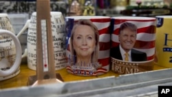 Coffee mugs for sale with the images of Democratic presidential candidate Hillary Clinton and Republican presidential candidate Donald Trump sit side by side on a shelf of a souvenir stand at the corner of Constitution Avenue NW and 17th Street NW in Washington, Tuesday, Feb. 16, 2016. (AP Photo/Carolyn Kaster)