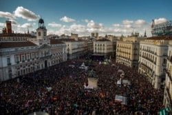 FILE - People fill the main square of Madrid during a march by members of the Podemos party, which hopes to emulate the electoral success of Greece's Syriza party in elections later this year, Jan. 31, 2015.