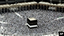 FILE - Muslim pilgrims prepare themselves for Friday prayers in front of the Kaaba, Islam's holiest shrine, at the Grand Mosque in the Muslim holy city of Mecca, Saudi Arabia, Sept. 9, 2016.