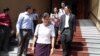 FILE - Opposition lawmaker Mu Sochua and her colleagues walk out of the Phnom Penh court room after a judge bans them from attending the hearing.