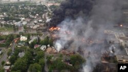 Smoke billows from fire at the site of a train derailment in Lac Megantic, Quebec, July 6, 2013.