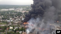 Smoke billows from fire at the site of a train derailment in Lac Megantic, Quebec, July 6, 2013.