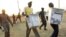 Men carry ballot boxes after elections in South Sudan in 2011. 
