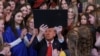 U.S. President Donald Trump holds up the "Keeping Men Out of Women's Sports" executive order after signing it in the East Room of the White House in Washington, Feb. 5, 2025.