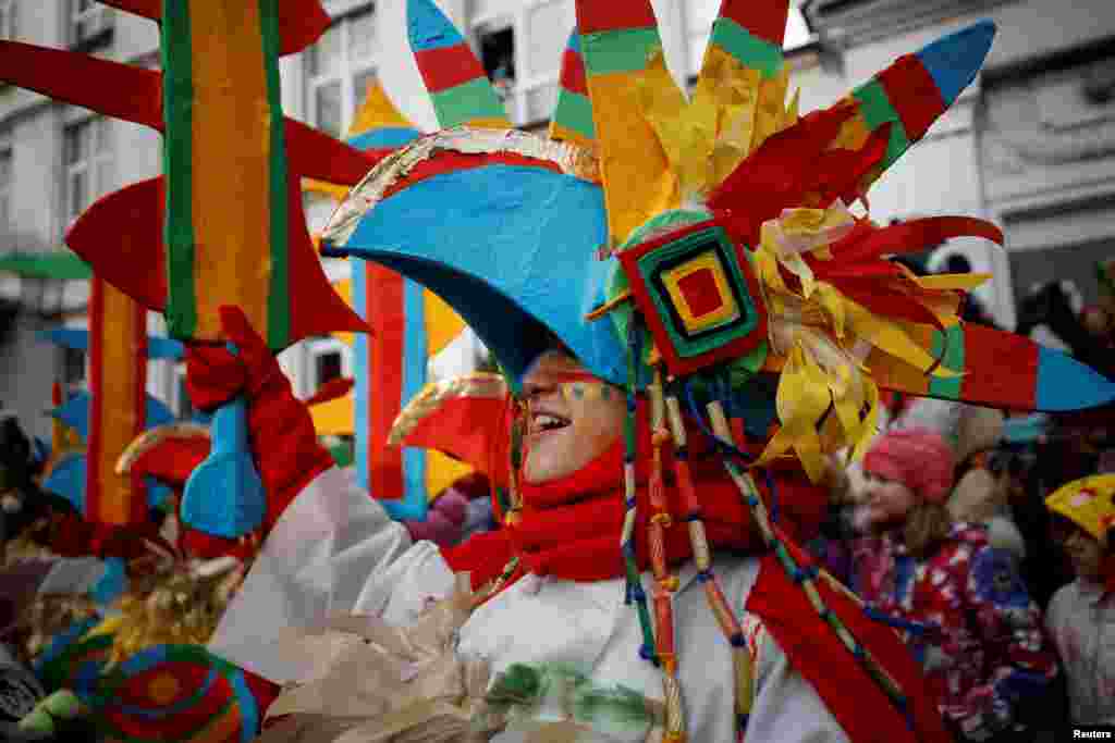 Participants dressed in fancy costumes take part in a performance as students and teachers of a local school celebrate Maslenitsa, also known as Pancake Week, which is a pagan holiday marking the end of winter, in central Moscow, Russia.