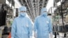 FILE - German Economy Minister Robert Habeck and Foreign Minister Annalena Baerbock wear protective suits during their visit to the semiconductor manufacturer of Infineon Technologies AG in Dresden, Germany, July 13, 2023. 