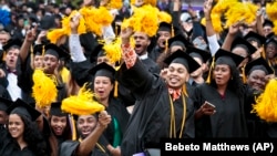 Graduating students in the Class of 2016 at City College of New York cheer.