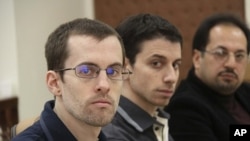 American hikers Shane Bauer (L) and Josh Fattal and their translator attend the first session of their trial in Tehran (file photo)