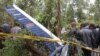 People gather at the scene where a police helicopter crashed at a forest in the Kibiko area of Ngong township, on the outskirts Nairobi, June 10, 2012. 